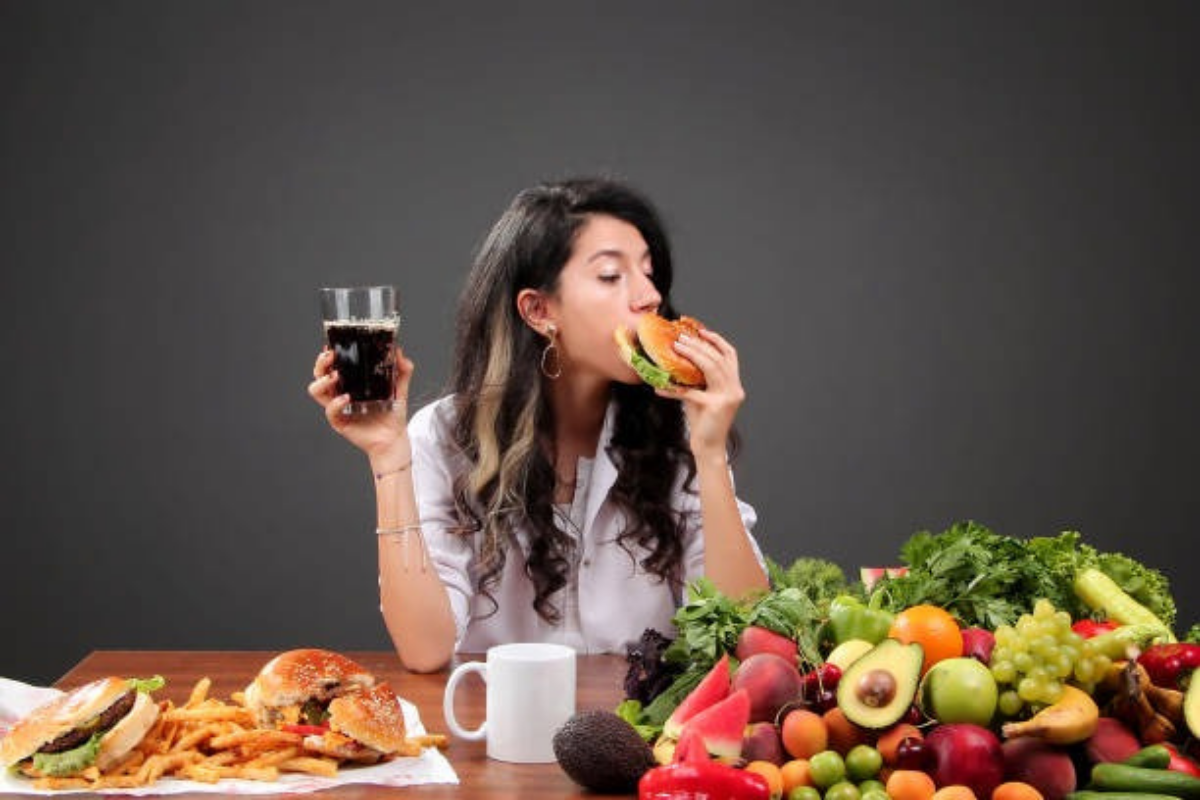 Woman choosing between fast food and healthy food options
